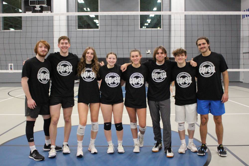 Students wearing championship shirts from a lower bracket volleyball tournament